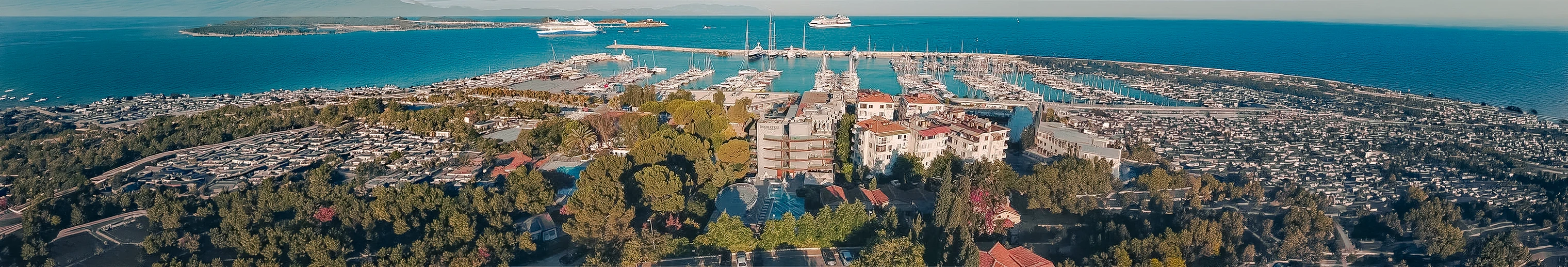 Aerial view of DoubleTree by Hilton Kuşadası, the marina and the blue Aegean Sea